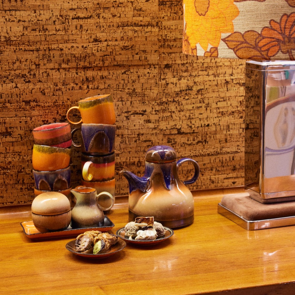 collection of ceramics from the hkliving 70s range on a wooden side board ready for afternoon tea