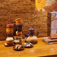 collection of ceramics from the hkliving 70s range on a wooden side board ready for afternoon tea
