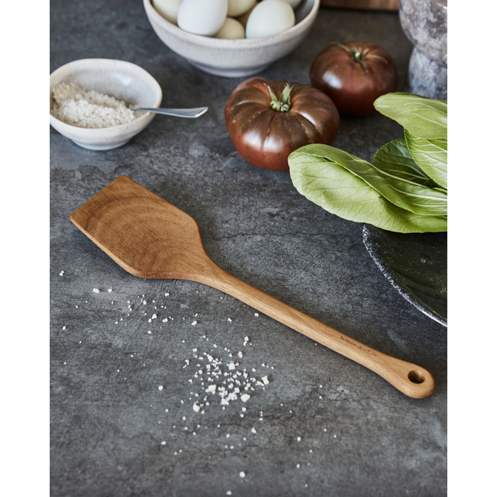 Acacia wood spatula on kitchen counter with vegetables – rustic kitchen utensil at North Home