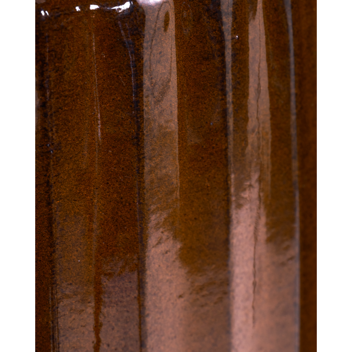 Close-up of glossy brown planter surface highlighting ribbed texture