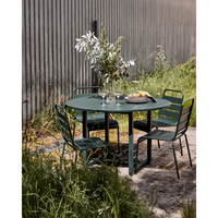 Round green iron outdoor table by House Doctor styled with matching chairs – North Home