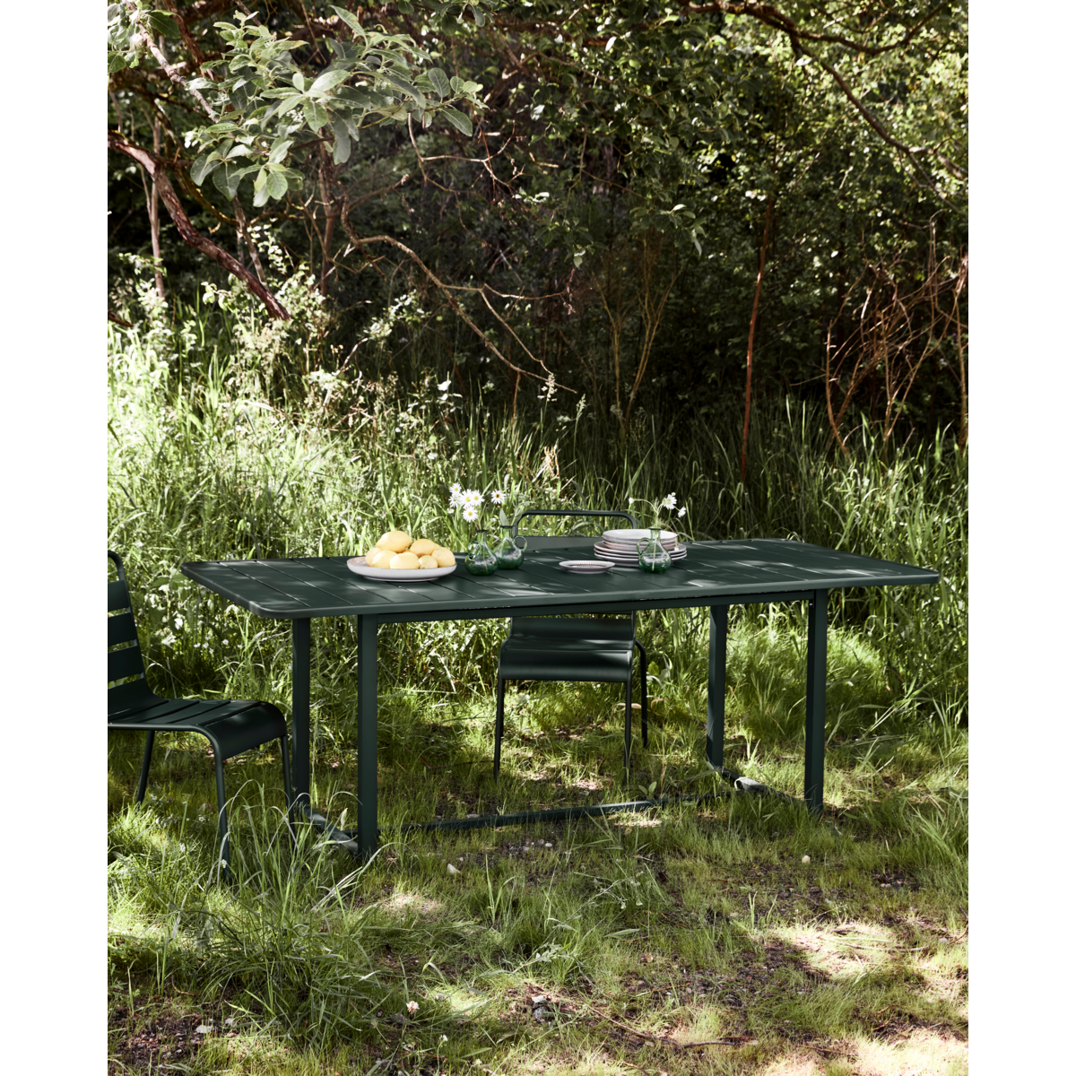 Rectangular green garden table by House Doctor styled in natural outdoor setting – North Home