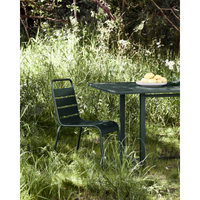 House Doctor Helo chair styled in grass setting next to green table
