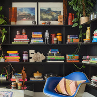 colourful objects in 70s style arranges on shelves in a room with books, other ceramics, and artwork. Cheerful objects that spark joy on observing from HKliving