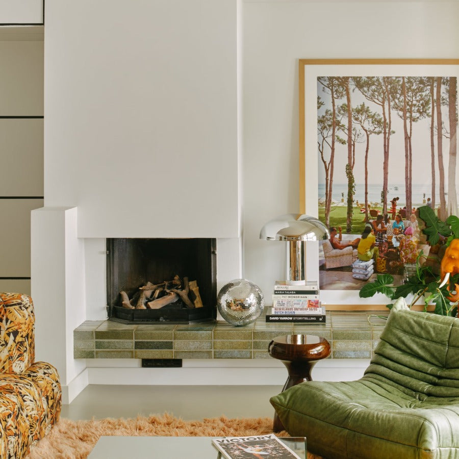 hkliving lounge lamp in chrome with a delicate light from the top and a lit up base in a setting filled with dutch designed furniture pieces in the indomnitable hkliving style