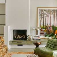 hkliving lounge lamp in chrome with a delicate light from the top and a lit up base in a setting filled with dutch designed furniture pieces in the indomnitable hkliving style