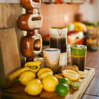 kitchen worktop with lemons, limes complimenting the joy 70s colours of tall coffee cups in browns and greens