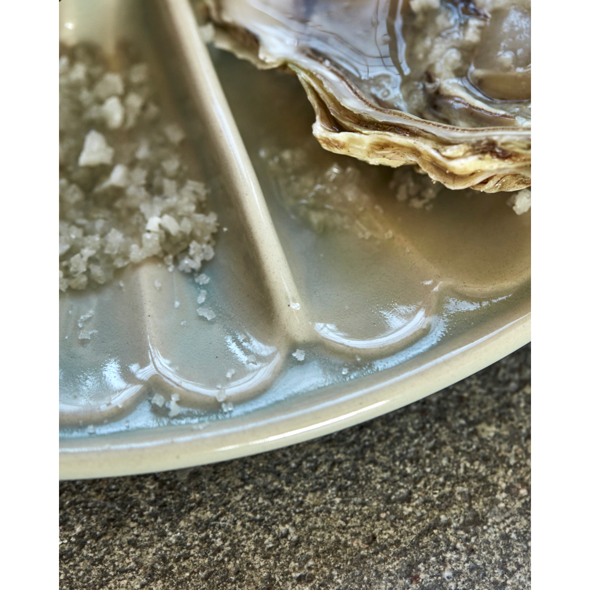 Detail of centre well and segment divider on light blue stoneware dish – elegant serving ware