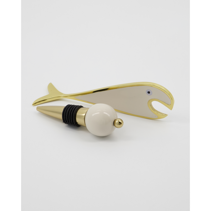 Gold-toned bottle stopper with round top and black silicone seal