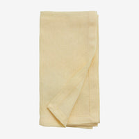 hand hemmed cloth yellow napkin folded neatly