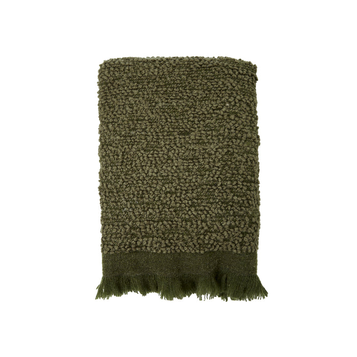 Deep green sofa throw with subtle fringe