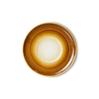 with the brighter, lighter beige in the centre part of the saucer going to a darker orangey brown to the outside like a sun