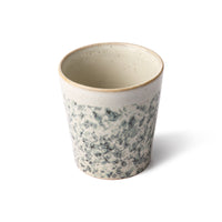 hk living coffee cup design hail which has the look of hail and rain as it spatters on a windscreen blocking your view before the winscreen wipers clear your view of the way ahead with blues greens and greys, a brown orange rim, and a beige inside