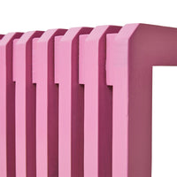 Vibrant pink sungkai wood bench styled as a feature piece in a large room