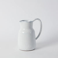 a stright sided jug with a long slender handle in white glaze handmade for style and difference