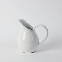handmade clay jug with a generous white glaze and a tall long spout