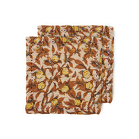 2 cloth napkins with image of tangerines on the branch with the brnaches in brown and yellow instead of green leaves creating an autumnal warmth from the hk living dutch design house