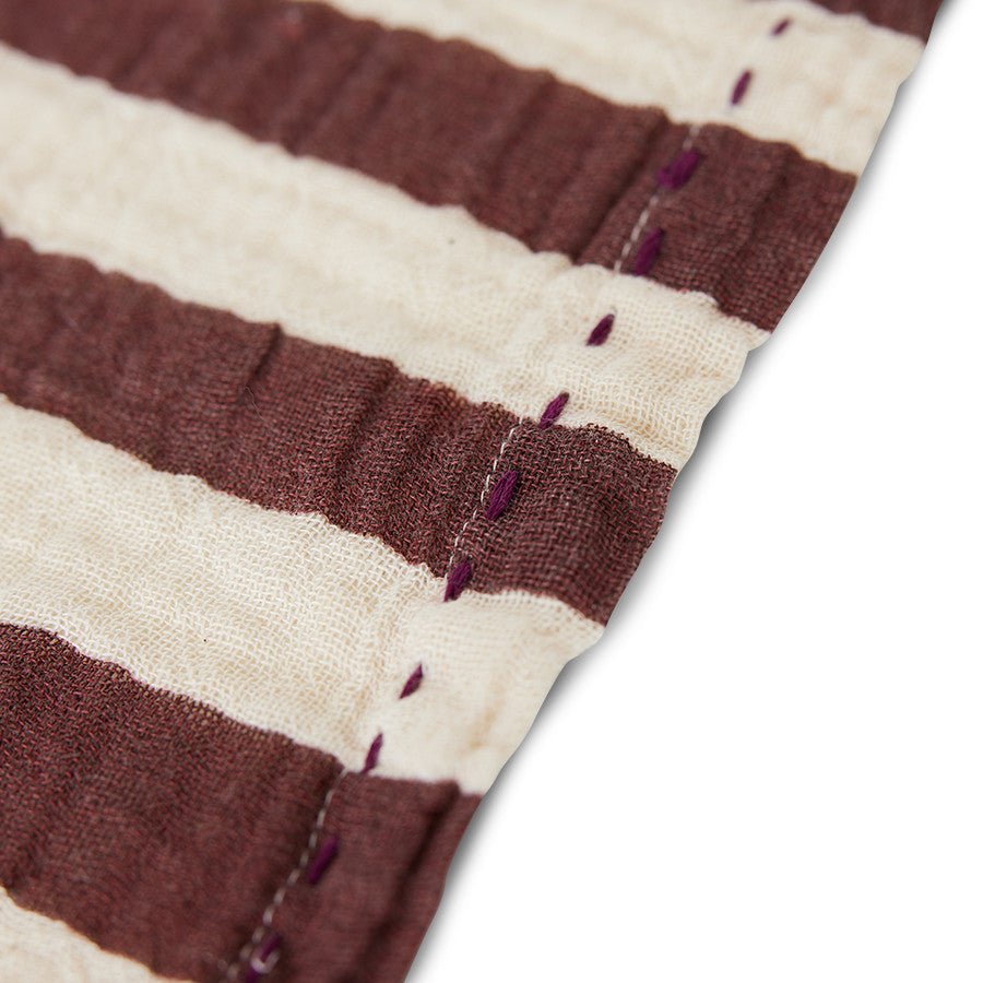 close up of burgundy and off creamy white striped cloth napkins from hk living