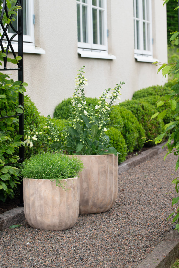 Wikholmform Fedora planters shown in garden setting