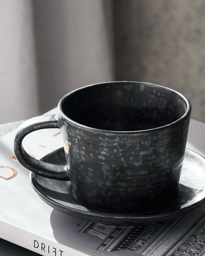 Black and brown stoneware cup with saucer by House Doctor.