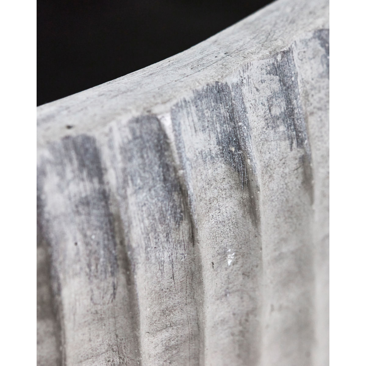 close up of textured surface on grey cement outdoor planter