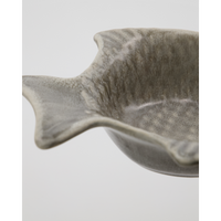 Close-up of handmade ceramic fish bowl with matte grey glaze