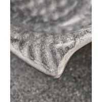 Close-up of handmade ceramic fish bowl with matte grey glaze