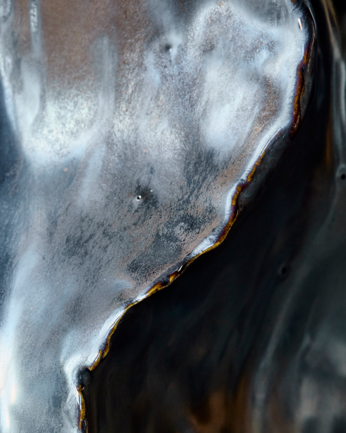 Close-up of the HDWaves vase showing the handmade organic texture and antique metallic sheen.