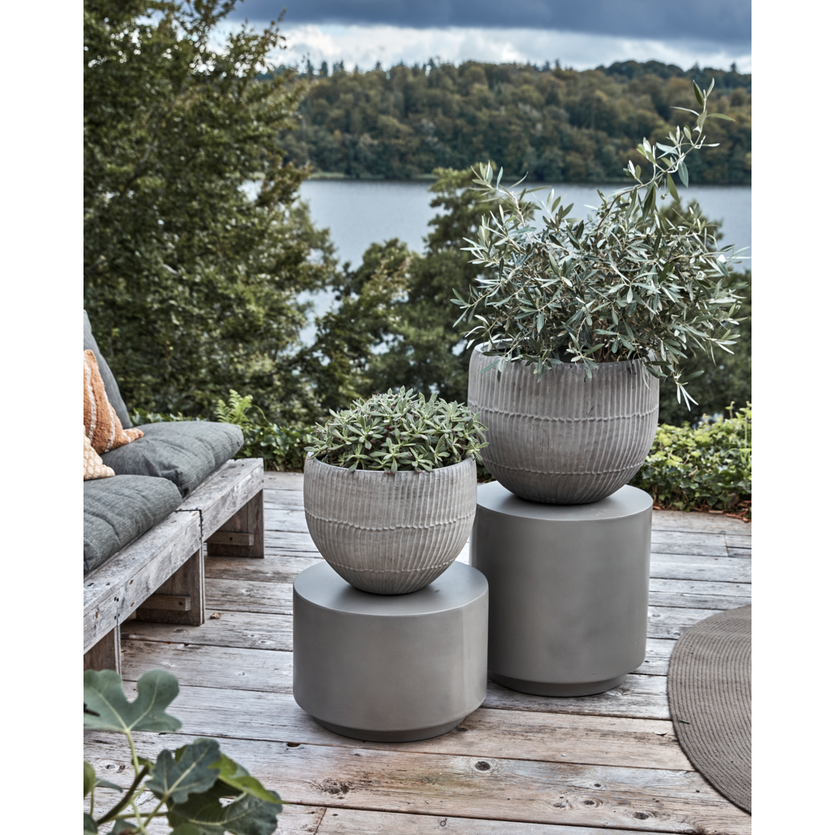 house doctor brave planters in grey cement styled outdoors with greenery
