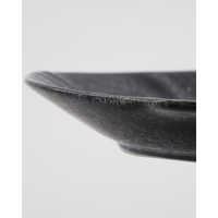 Close-up of textured black ceramic fish serving bowl by House Doctor