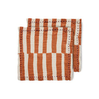 tangerine and off white stripe cloth napkins with a purple stich around the outer edge from nordic design house hk living