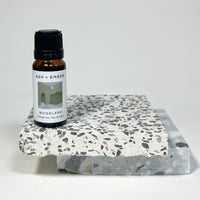 Woodland Essential Oil Blend by Ash + Ember in 10ml amber glass bottle with pine and cedar scent