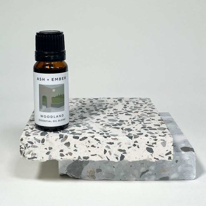 Woodland Essential Oil Blend by Ash + Ember in 10ml amber glass bottle with pine and cedar scent