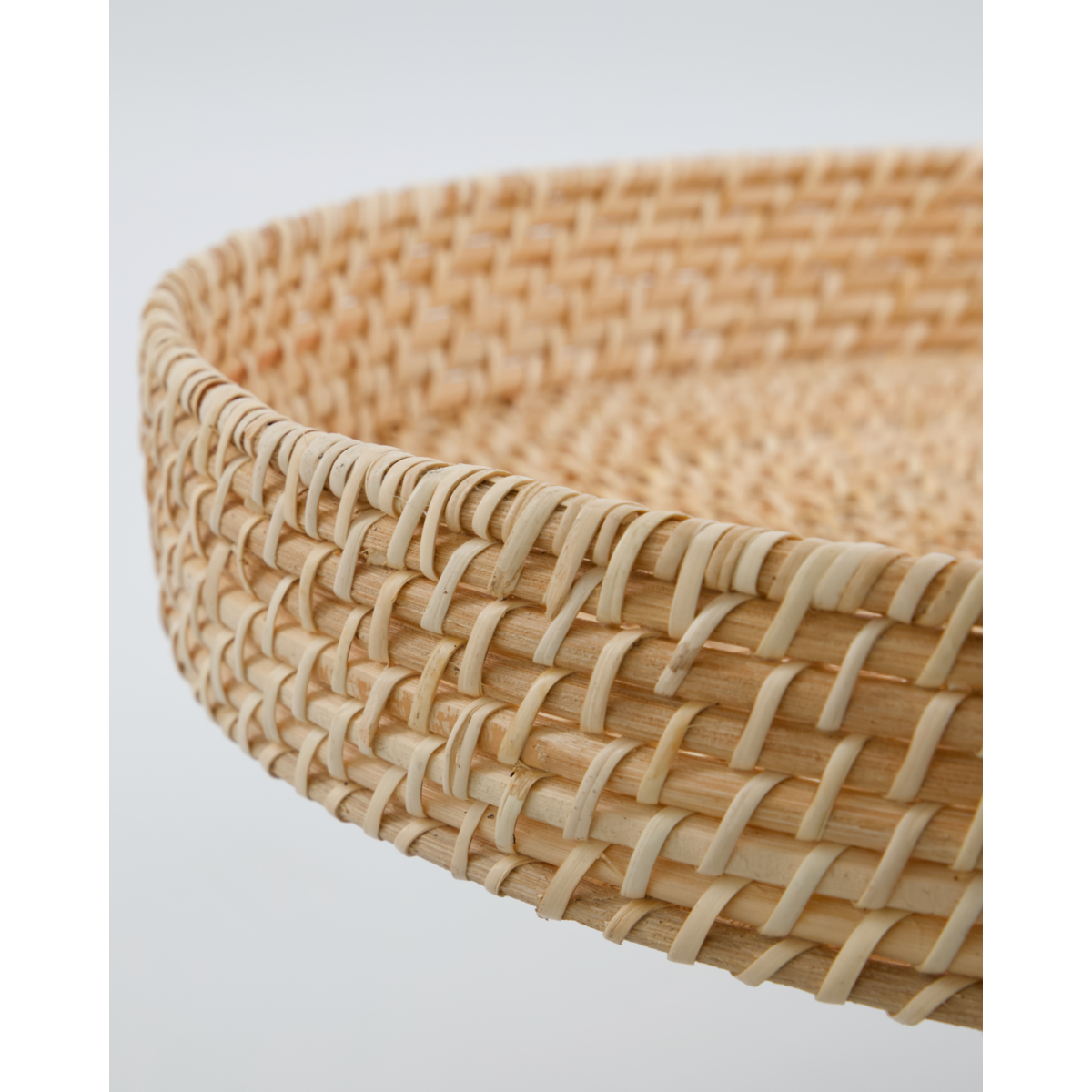 close up of woven rattan tray edge showing handmade detail