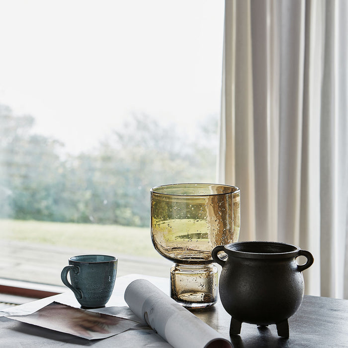 Rounded amber-toned vase on neutral background