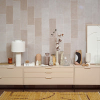 a number of hkliving vases and art pieces in a row on a furniture piece