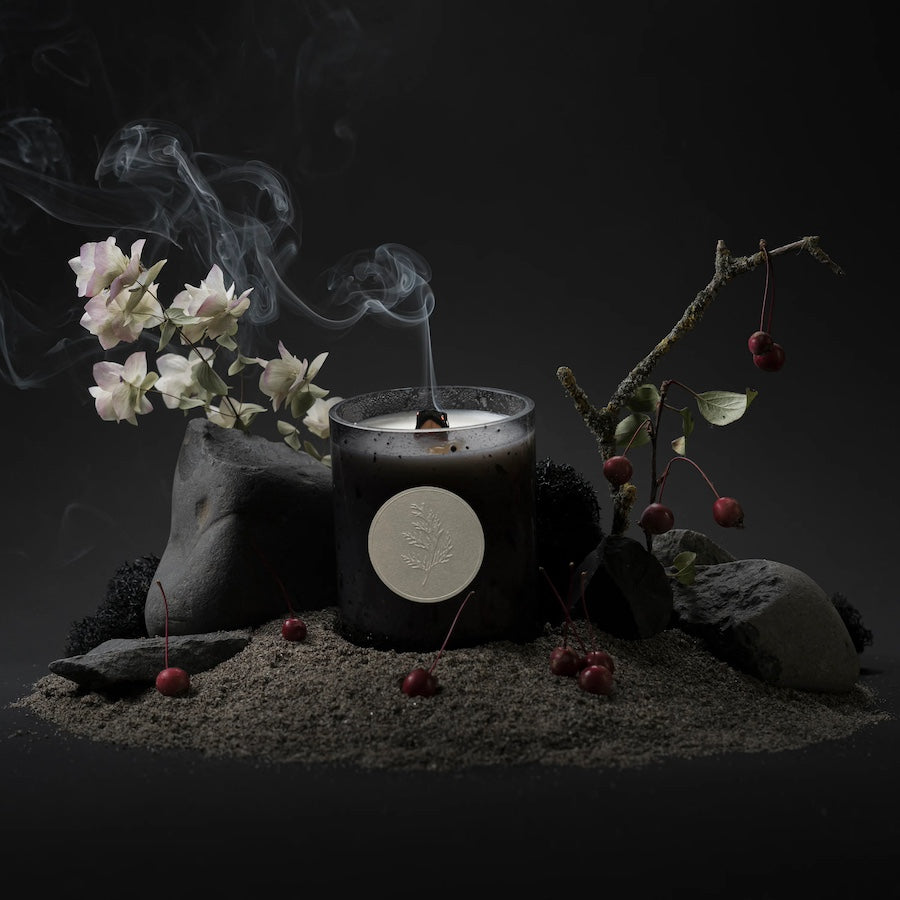 A candle from new supplier Fischersund of Iceland having just been blown out surrounded by flowers and berries