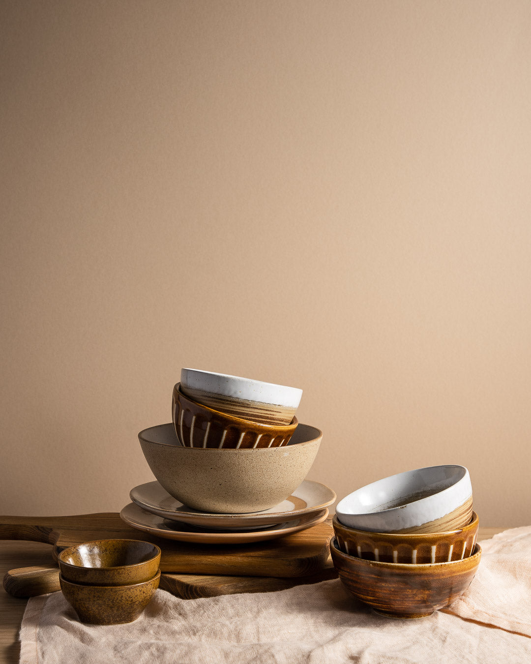 a stack of items from HKlivings Kyoto range of bowls in shades of brown and white