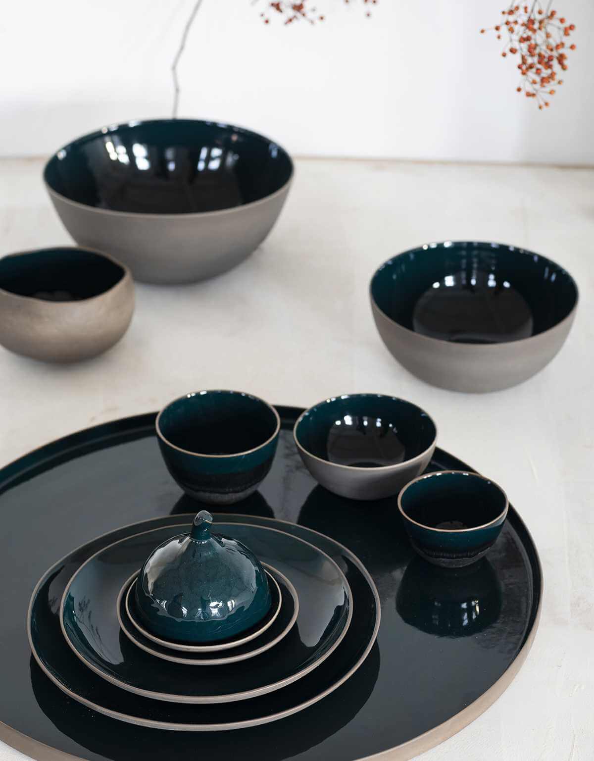 selection of bowls and plates that are greenish blue but all with an amazing sprakling glaze