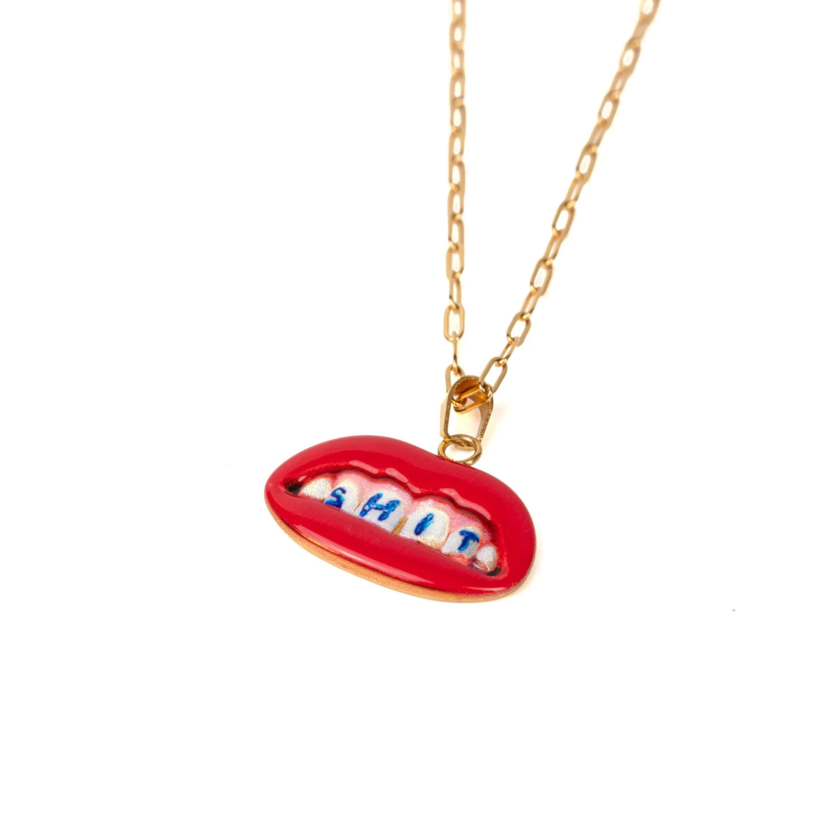 Necklace with a red lip-shaped pendant displaying the word 'SHIT' in blue on the teeth on a white background