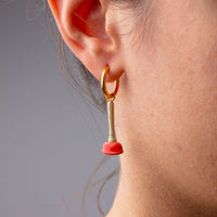 sink plunger dangling earring by Seletti Toiletpaper worn on ear for playful style