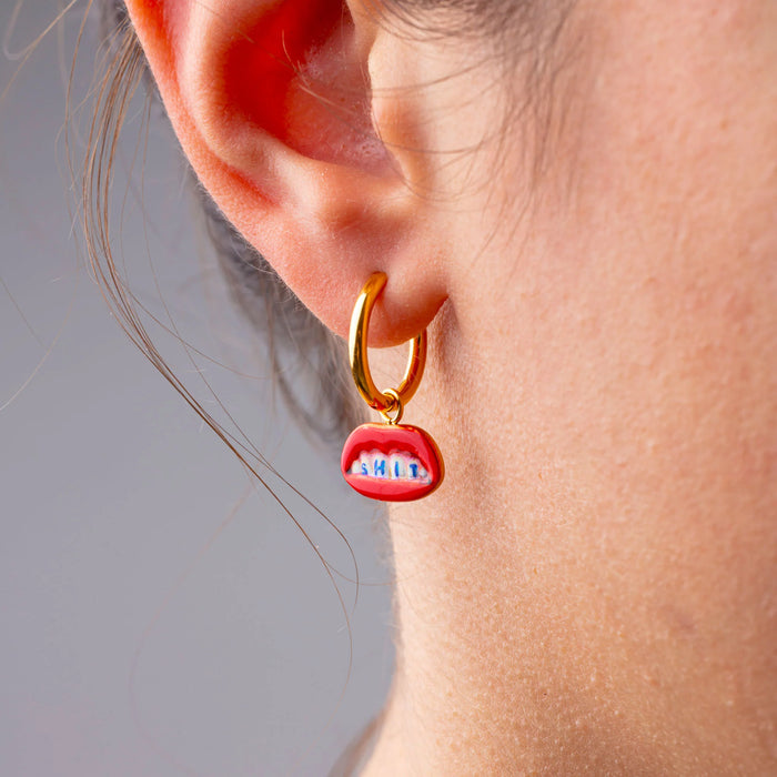 SHIT dangling earring by Seletti Toiletpaper worn on ear for playful style
