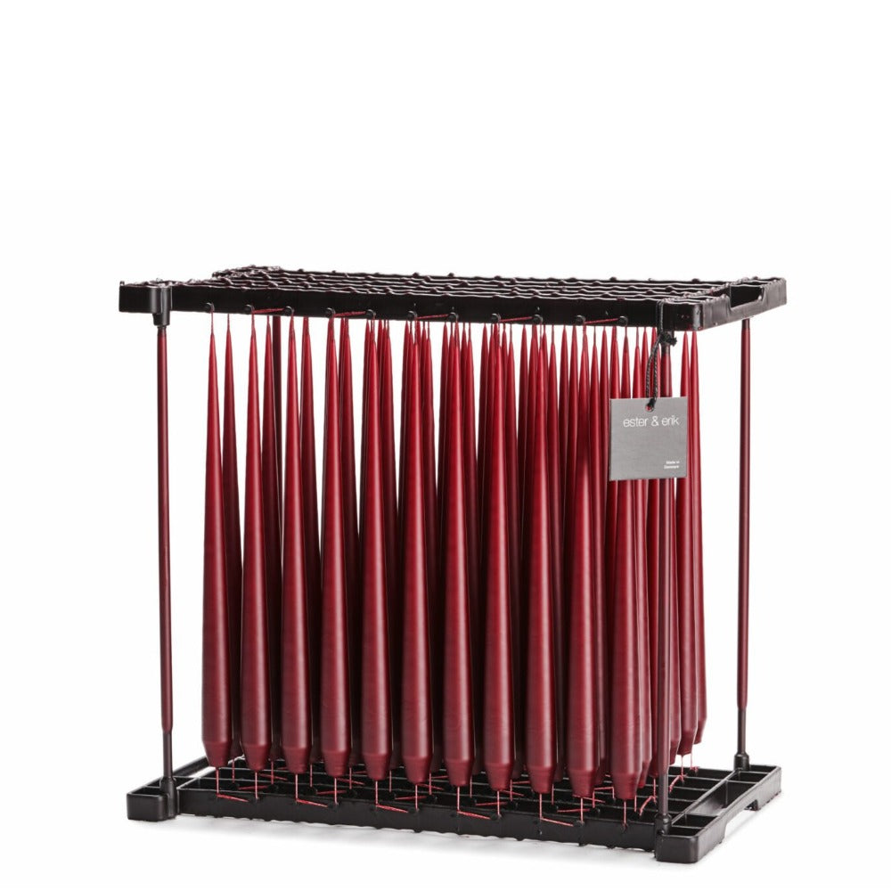 Deep Wine coloured taper candles in dipping rack