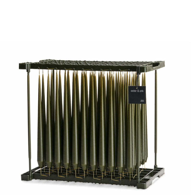 deep forest coloured taper candles on dipping rack