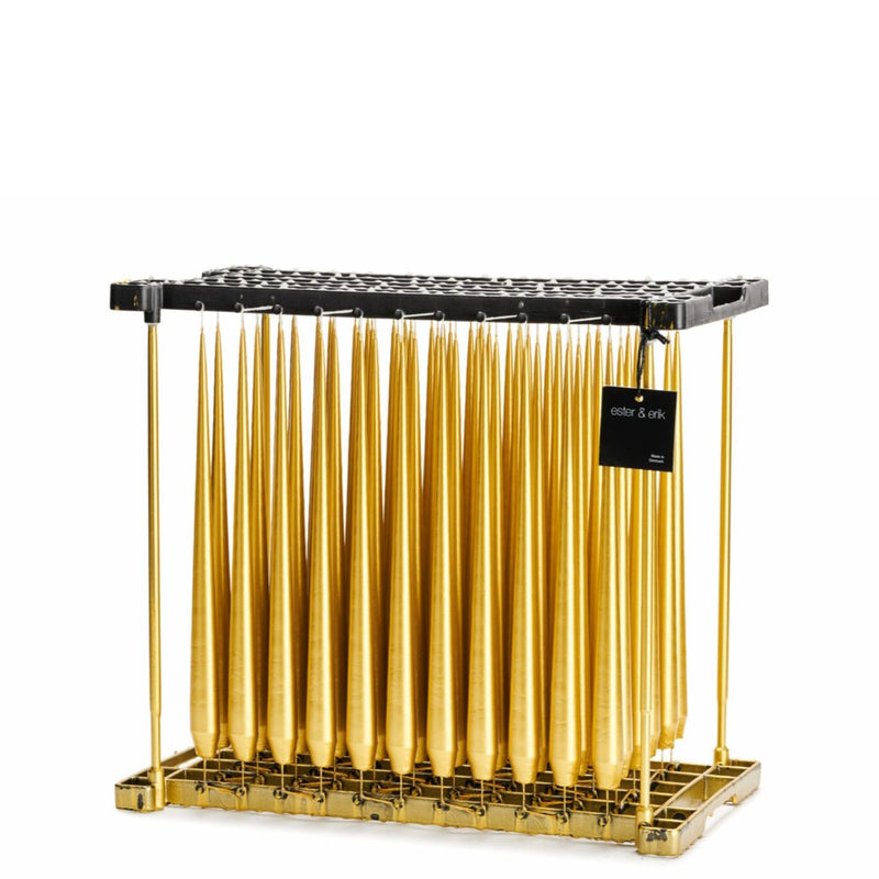 Metallic gold taper candles in dipping rack