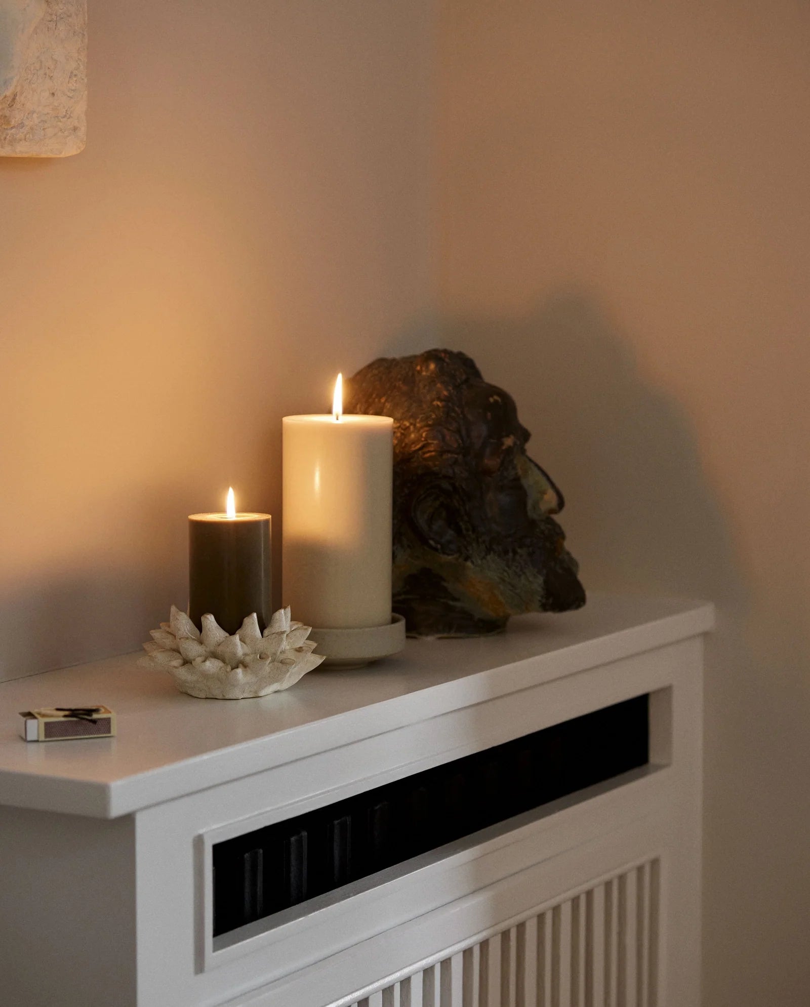Beige pillar candle by Nordal styled in a home interior setting