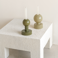 pair of olive tone pallo a glass candle holders styled on textured white table