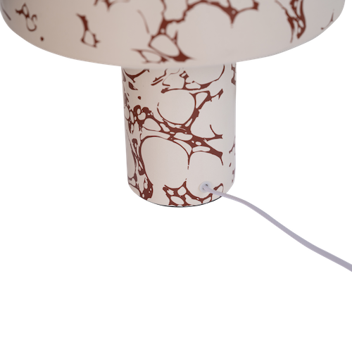 detail of ceramic base showing brown marble-effect pattern on Fluido lamp
