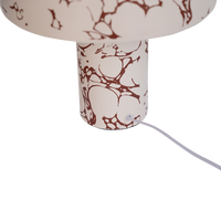 detail of ceramic base showing brown marble-effect pattern on Fluido lamp
