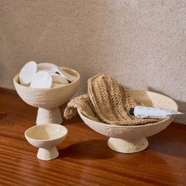 small speckled urban nature culture lav bowl on a bathroom shelf used for cotton pads